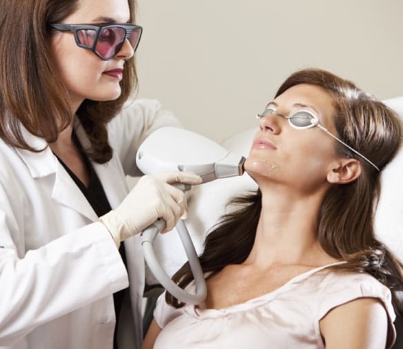 lady is doing electrolysis hair removal for a female client